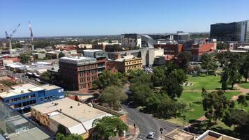 A cityscape with various buildings, roads, and greenery.