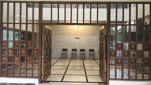 A traditional Japanese-style entrance with sliding doors, a tiled floor, and a red mat at the entrance. - Park Hotel and Resort (Anekal)