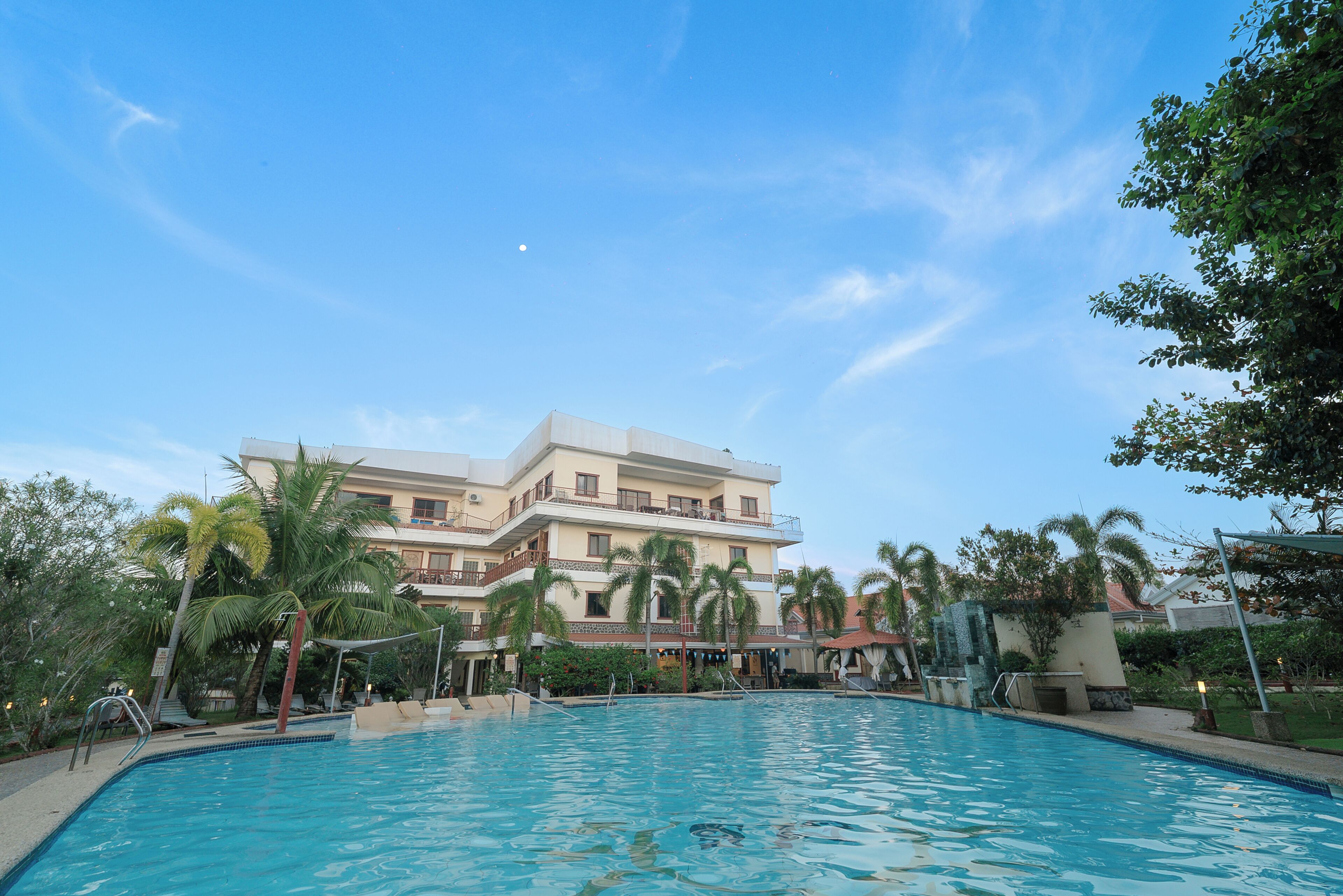 A swimming pool with a building in the background.