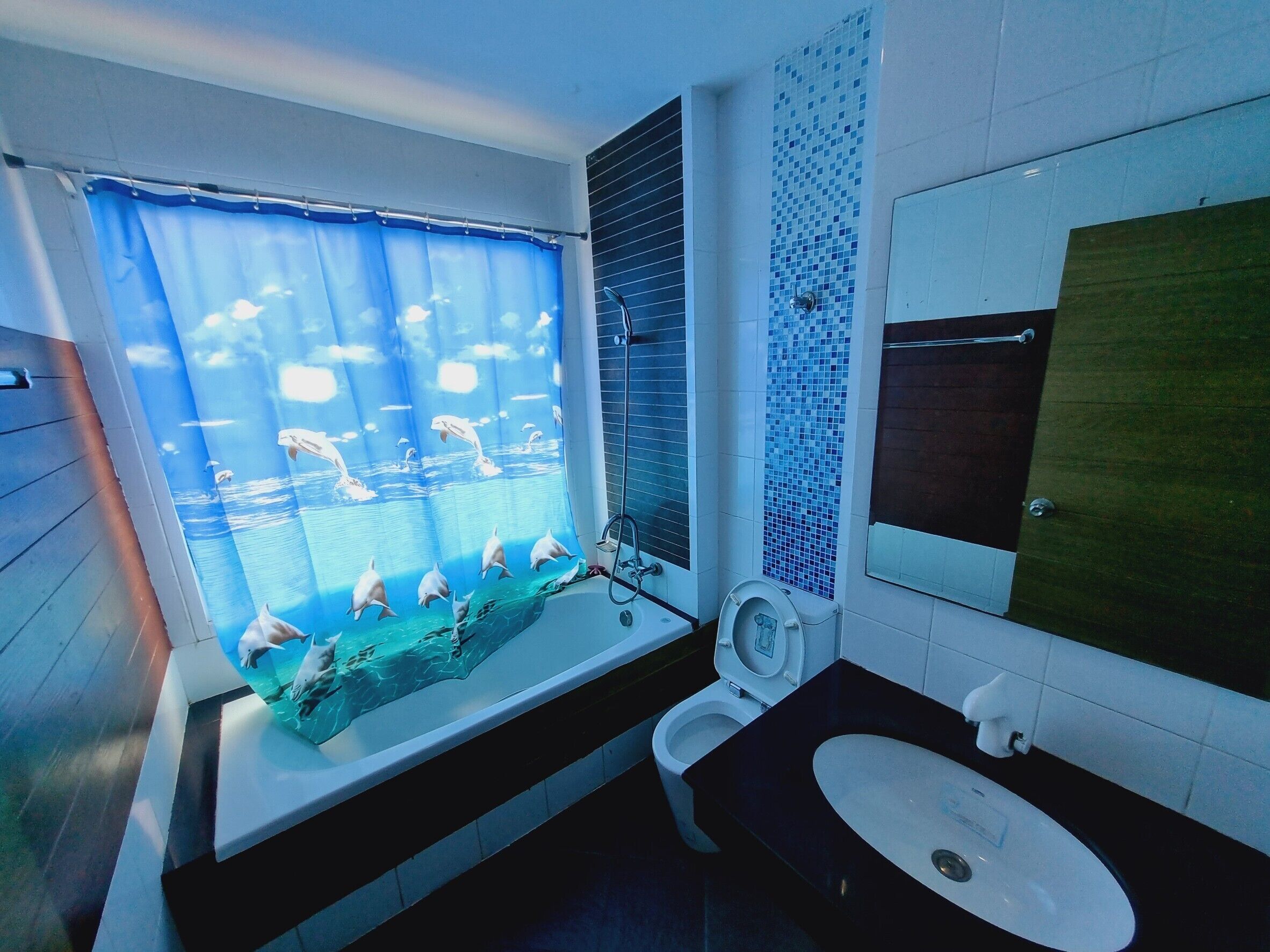 A bathroom with a bathtub, toilet, and sink.