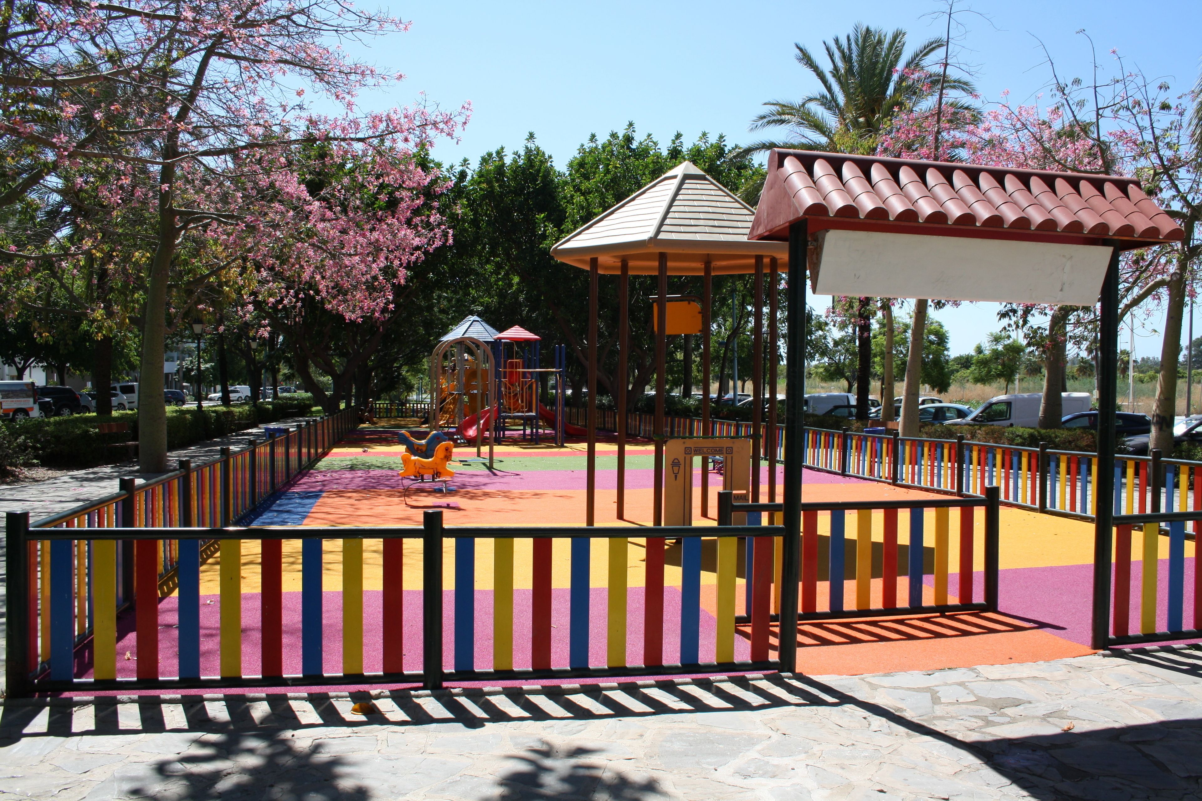 A playground with colorful play equipment and a gazebo.