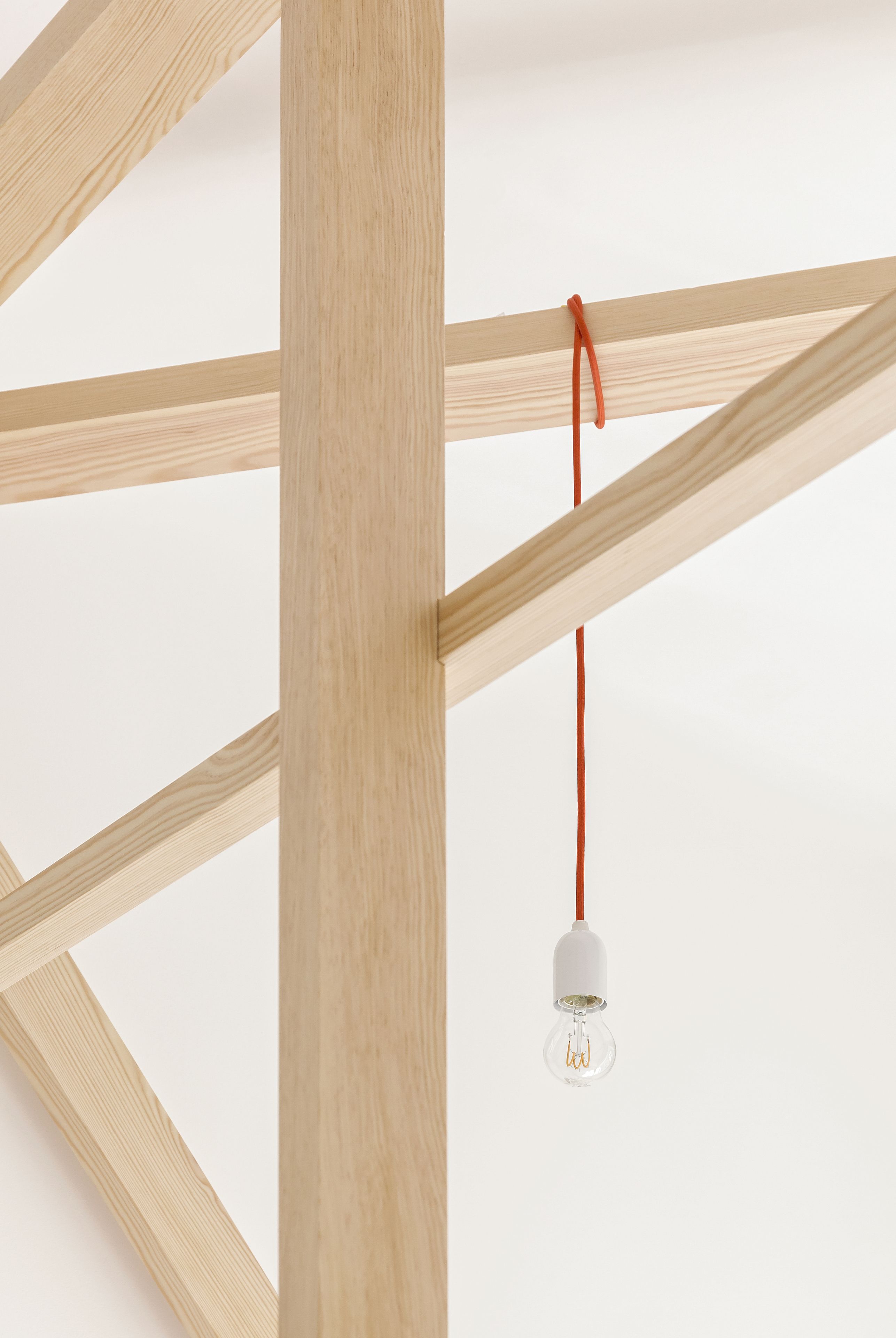 A wooden structure with a hanging light bulb.