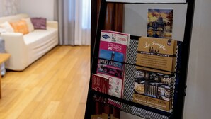 A hotel room with a sign reading "Sofia's Suites" and a display rack with various brochures and packages. - Sofia's Suites Guesthouse (Rome)