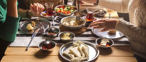 A dining table with various dishes, utensils, and condiments.