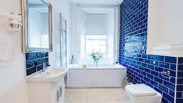 Deluxe Suite, Bathtub | Bathroom | Free toiletries, hair dryer, towels, soap