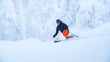 A person skiing down a snowy slope.