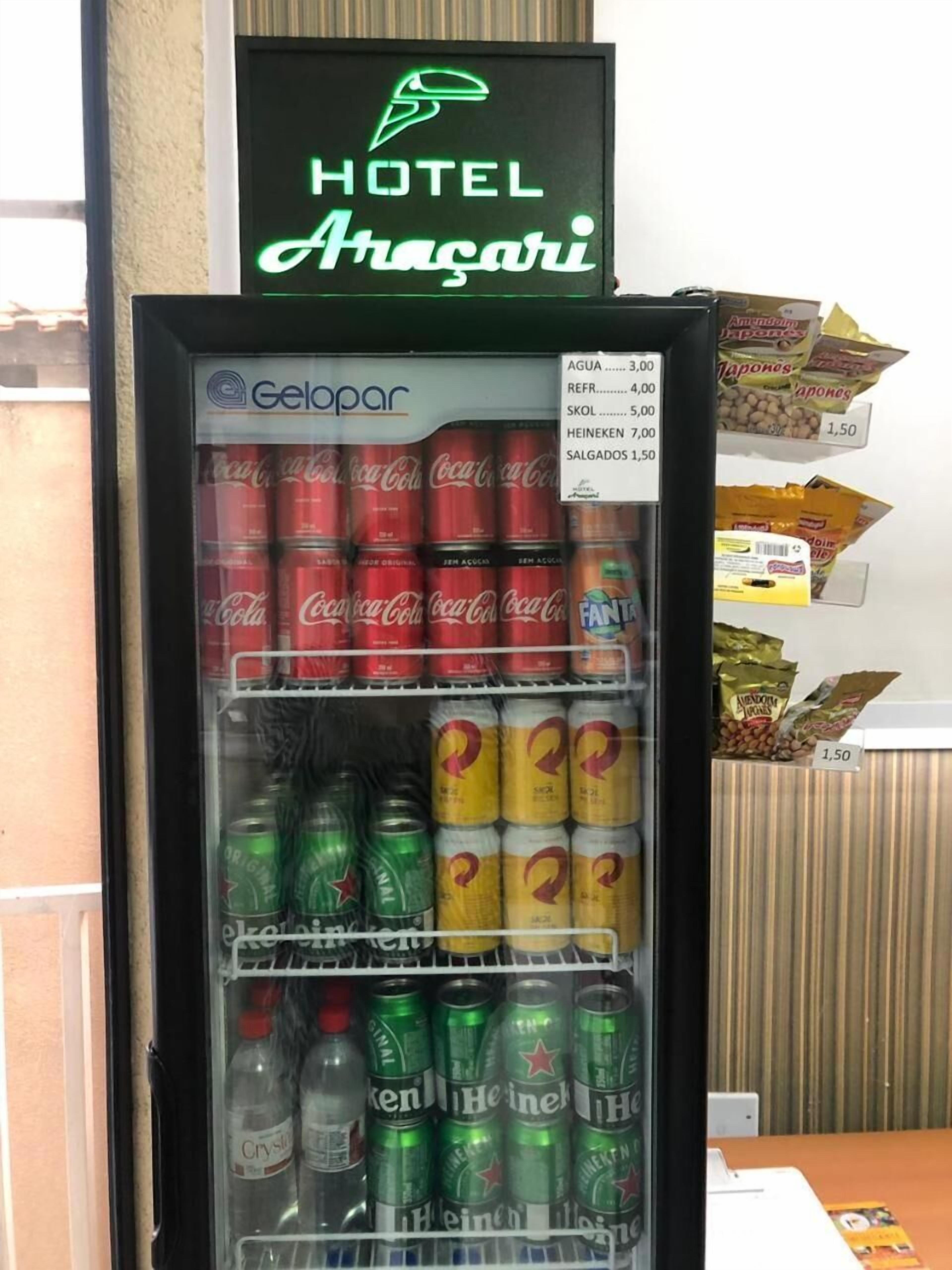 A vending machine stocked with Coca-Cola, Fanta, and Heineken.