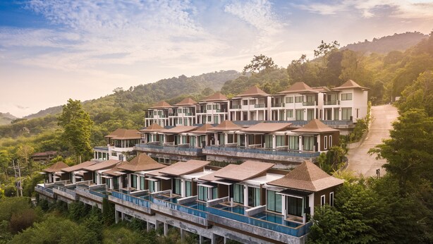 A multi-story resort with balconies and a swimming pool, surrounded by lush greenery and hills. - Andakiri Pool Villa Panoramic Sea View (Krabi)