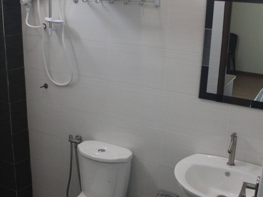 Un baño con inodoro, lavabo, toallero con toallas y cabina de ducha.