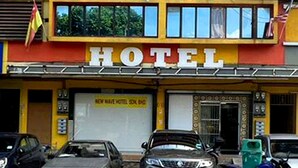 A multi-story hotel with a prominent 'HOTEL' sign on the facade.