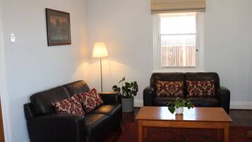 Upper Reach Spa Cottage | Living area | Flat-screen TV, fireplace, DVD player