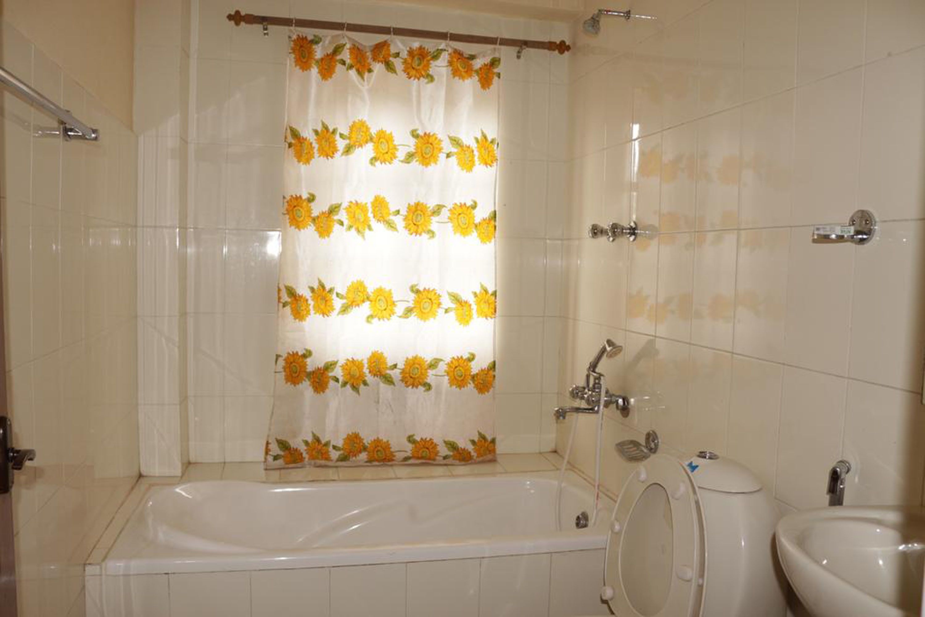 A bathroom with a bathtub, a toilet, and a sink.