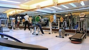 A gym with various exercise equipment, including weight machines and free weights.