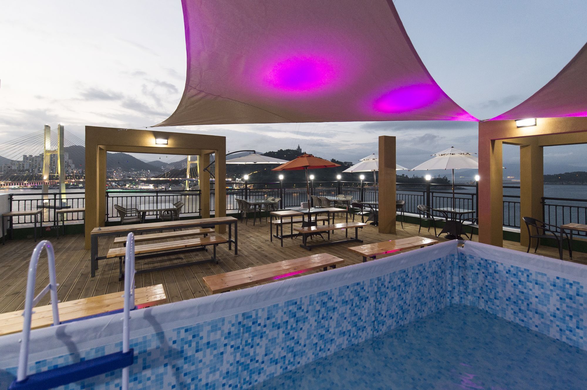 Seasonal outdoor pool, open 3:00 PM to 10:00 PM, pool umbrellas