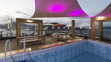 Seasonal outdoor pool, open 3:00 PM to 10:00 PM, pool umbrellas