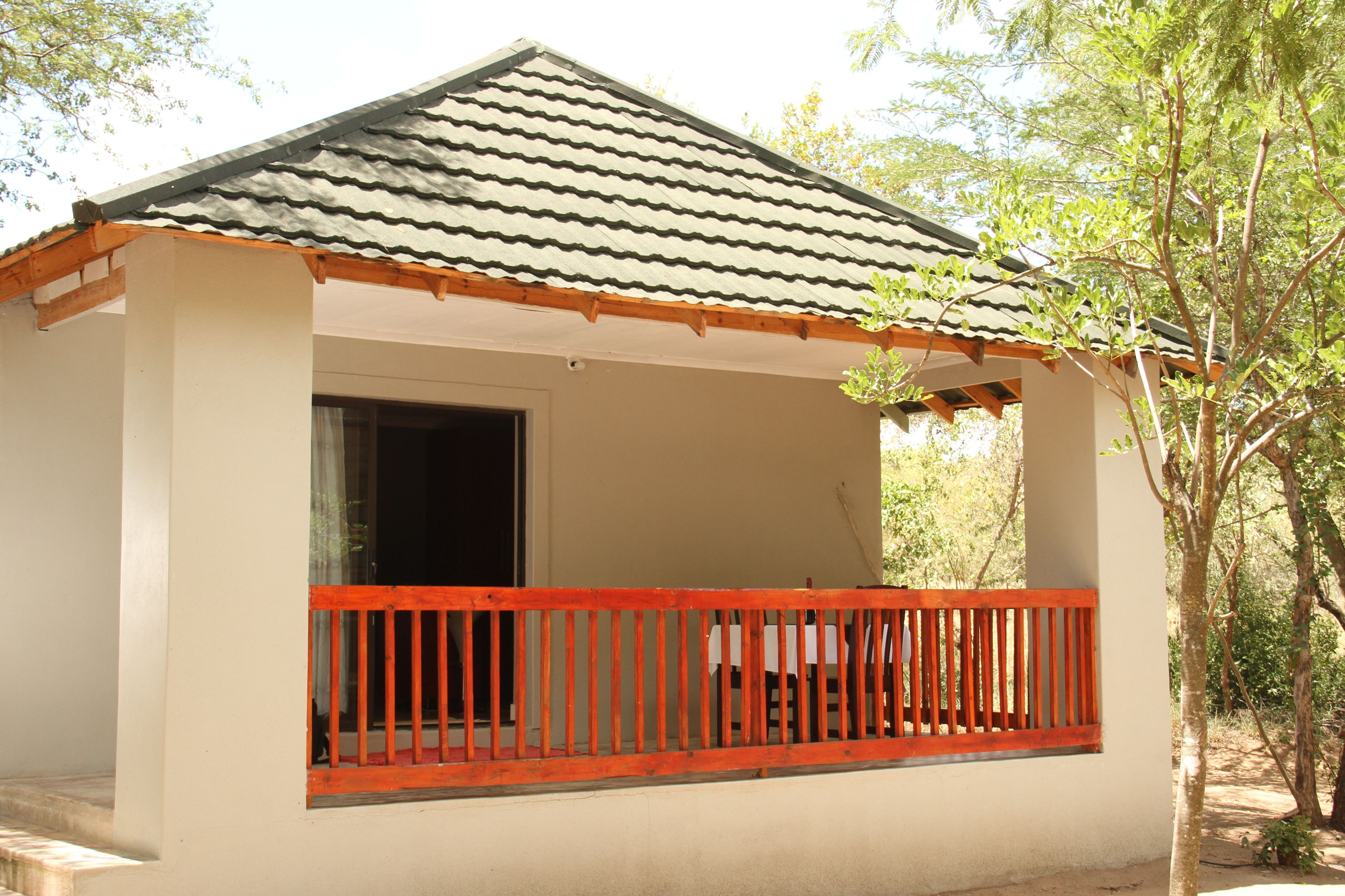 A small building with a tiled roof and a wooden balcony railing.