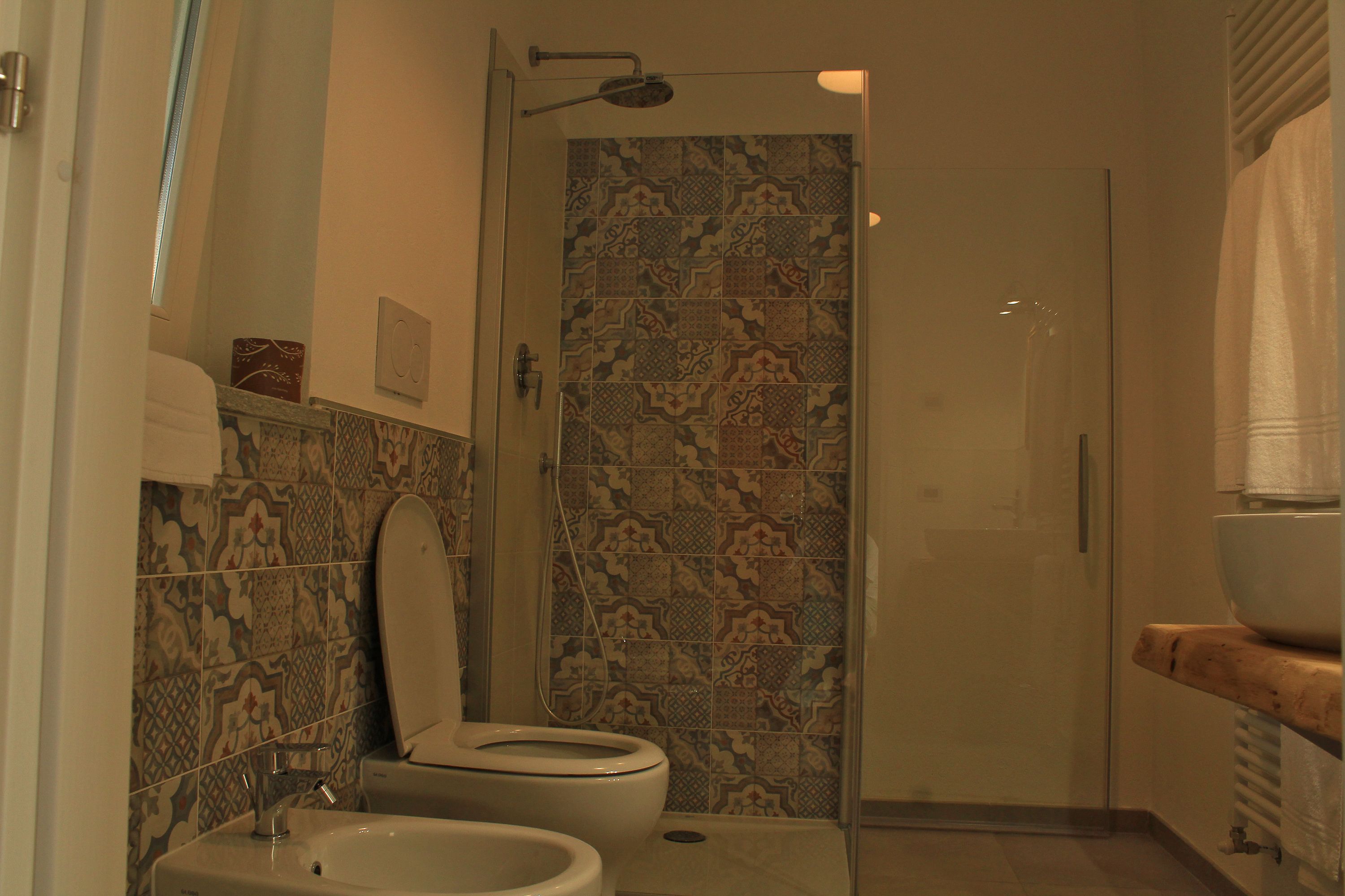 A bathroom with a shower, toilet, and sink.