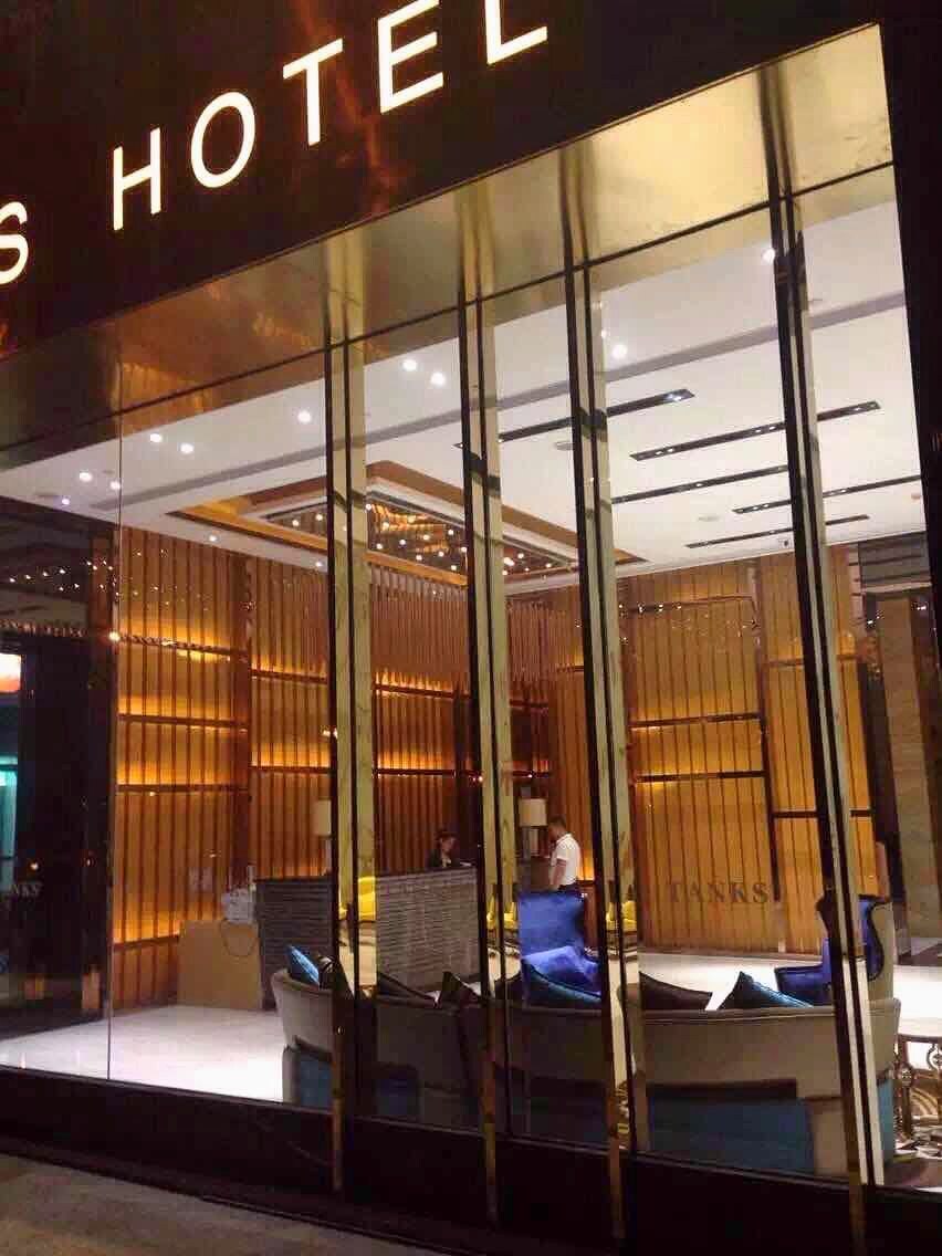 A hotel with a modern interior, visible through large glass windows.