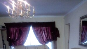 A living room with a sofa, armchair, and coffee table. - The Royal Princess Garden - Honeydew (Roodepoort)