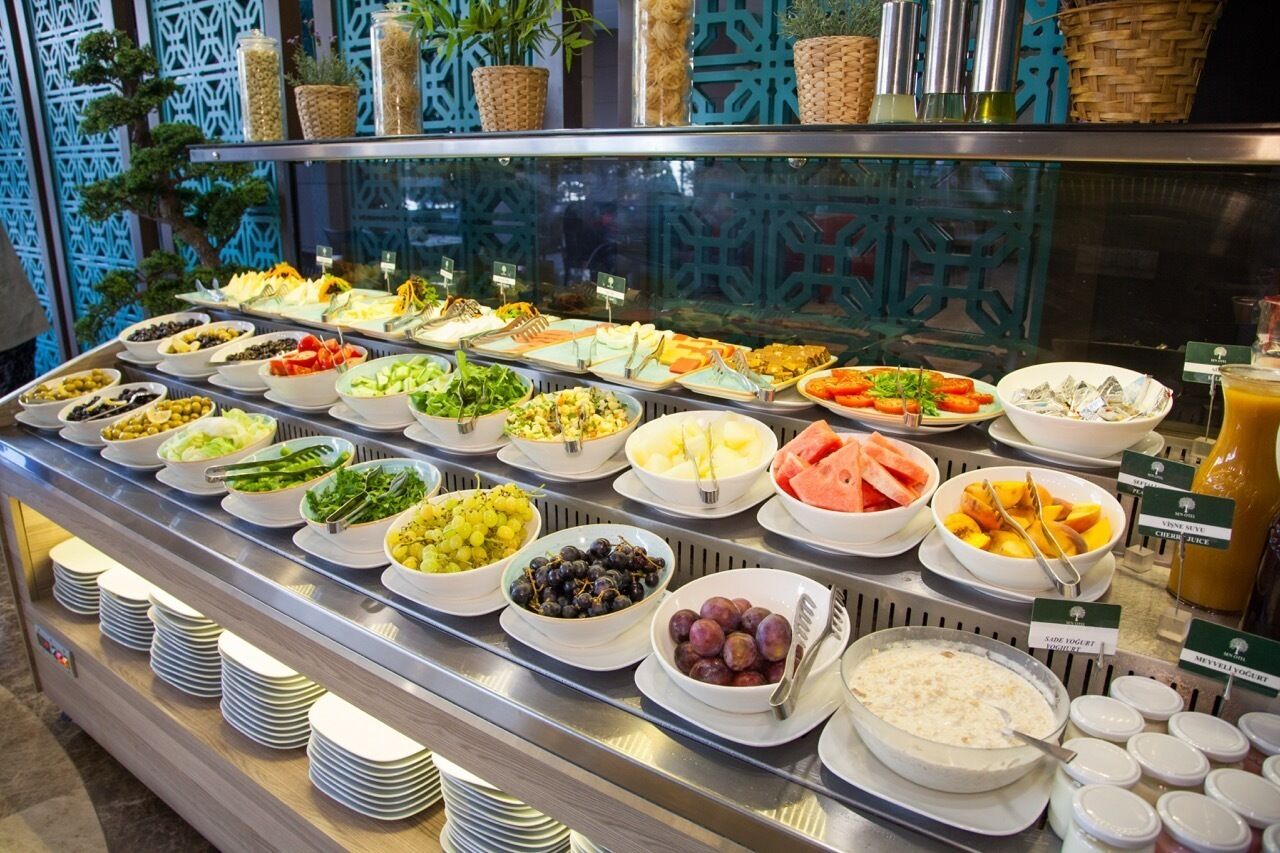 A buffet with various food options and a beverage station.