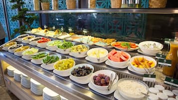 A buffet with various food options and a beverage station.