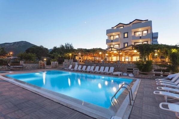 Piscine extérieure, parasols de plage, chaises longues