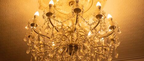 A chandelier with multiple crystal elements and light fixtures.