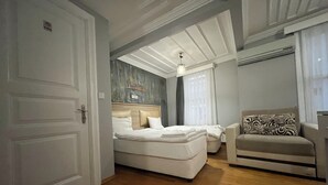 A bedroom with a double bed, a chair, and a small table. - Jasmine Apartment (Istanbul)