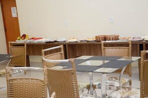 Un buffet proposant une variété de plats et agrémenté de chaises en osier.
