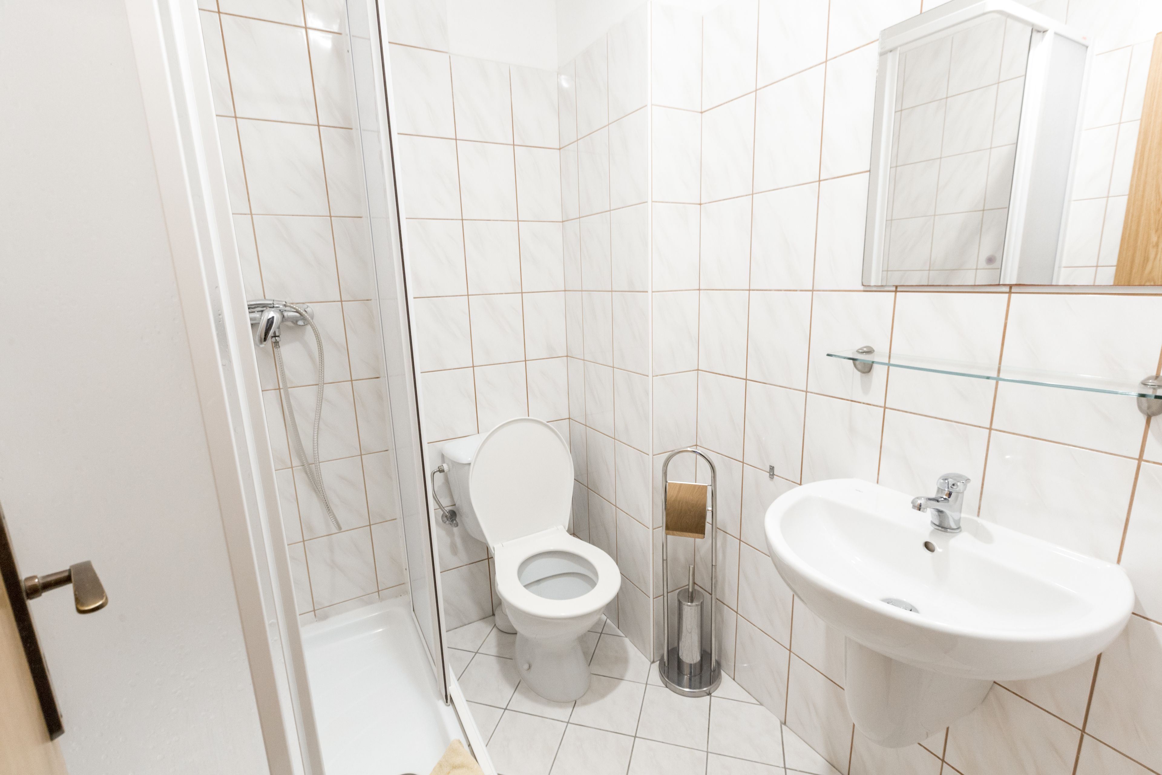 A modern bathroom with a toilet, bidet, and sink.