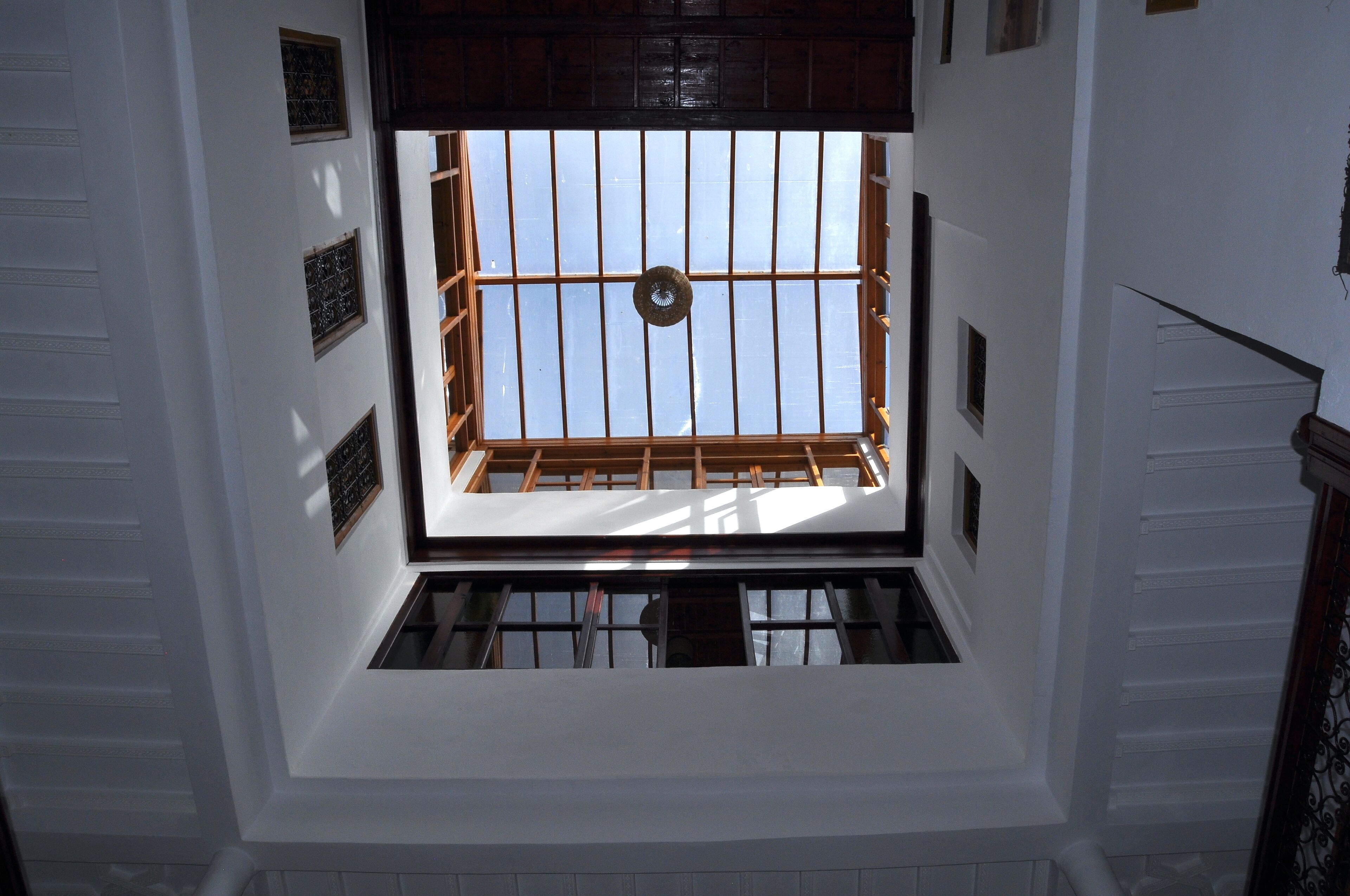 A room with a skylight, wooden beams, and a view of the sky.