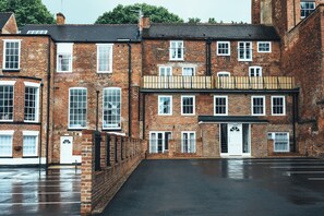 A multi-story brick building with a central entrance, large windows, and a flat roof. - The Stay Company Friar Gate (Derby)