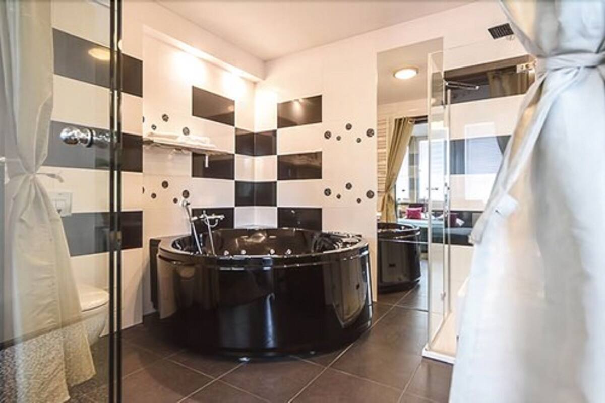 luxury apartment | in-room safe, desk, blackout curtains, iron/ironing board