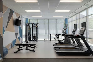 A gym with treadmills, a bench, and a weight machine. - SpringHill Suites by Marriott Allentown Bethlehem/Center Valley (Center Valley)
