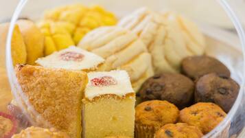 A variety of baked goods including muffins, cookies, and a cake.