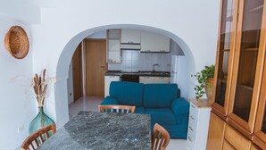 A compact kitchen with white cabinets and a built-in oven. - Trullo la Chianca Homerelax (Locorotondo)