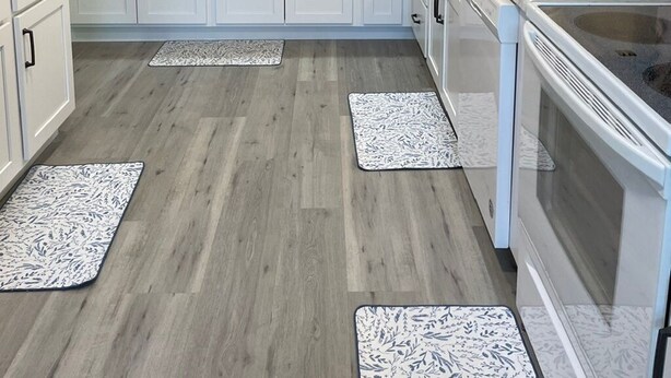 A modern kitchen with white cabinets, a large island, and a built-in oven. - Newly Updated, 2 King Beds, Pools, Hot Tub & Golf Course Views! Feels like home! (Branson)