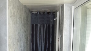 A narrow corridor with a glass door leading to a balcony. - Comfortable cottages in Auvergne 4-6 people (Espinchal)