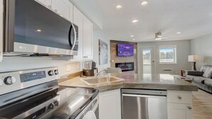 A modern kitchen with an LG oven, a dishwasher, and a built-in TV. - The Docksider - Couples & Young Families - Lakefront! (Wisconsin Dells)