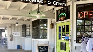 A storefront with a sign reading "The Trading Post Deli Groceries Ice Cream."