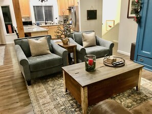 Relax in this inviting living space with two sofas, a coffee table, and a blue cabinet.