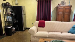 A living room with a sofa, a coffee table, and a dining table. - Perfect for work or fun! 1 NIGHT RENTAL AVAILABLE! (College Station)