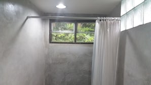 A bathroom with a shower, a window, and a curtain. - 339 Hotels & Resort (Nakhon Ratchasima)