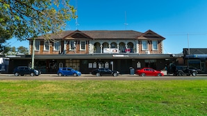 A hotel with a classic architectural style, featuring a central arched entrance and multiple windows. - Swansea Hotel (Swansea)