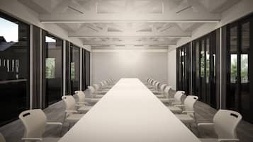 A conference room with a long table, chairs, and large windows.