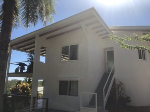 A modern two-story building with a flat roof, multiple windows, and a staircase leading to the upper floor. - Chez Mu Luxury Villa - Amazing Ocean & Jungle Views 1 Mi/TownNew Pictures!!! (Montezuma)