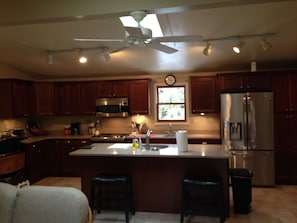 Enjoy cooking in this well-equipped kitchen with a central island and stainless steel appliances.