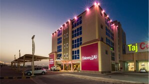 A multi-story hotel with a prominent 'Taleen' sign, featuring a modern architectural design with a flat roof and large windows. - Taleen Al Hasa (Al-Hofuf)
