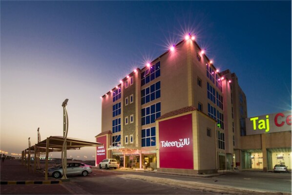 A multi-story hotel with a prominent 'Taleen' sign, featuring a modern architectural design with a flat roof and large windows. - Taleen Al Hasa (Al-Hofuf)