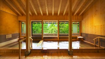 A traditional wooden bathhouse with wooden benches and a wooden floor.